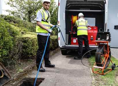 2 Drain Doctor engineers working from van