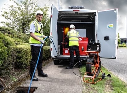 2 Drain Doctor engineers working from van