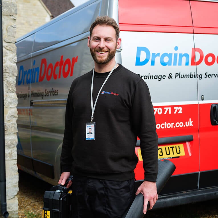 Drain Doctor engineer walking towards van