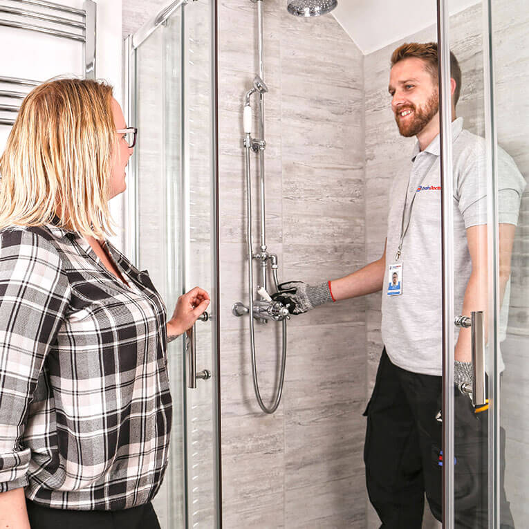 Drain Doctor engineer with customer by shower