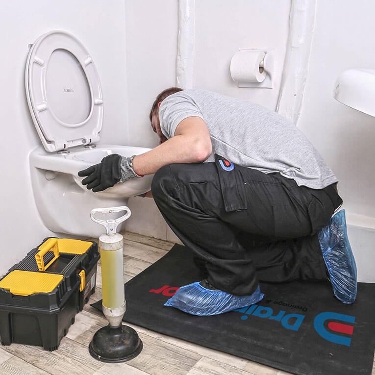 Engineer fixing broken toilet