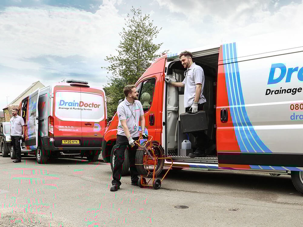 Multiple Drainage engineers with two vans on road