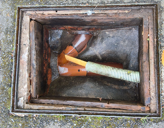 Open manhole revealing drain